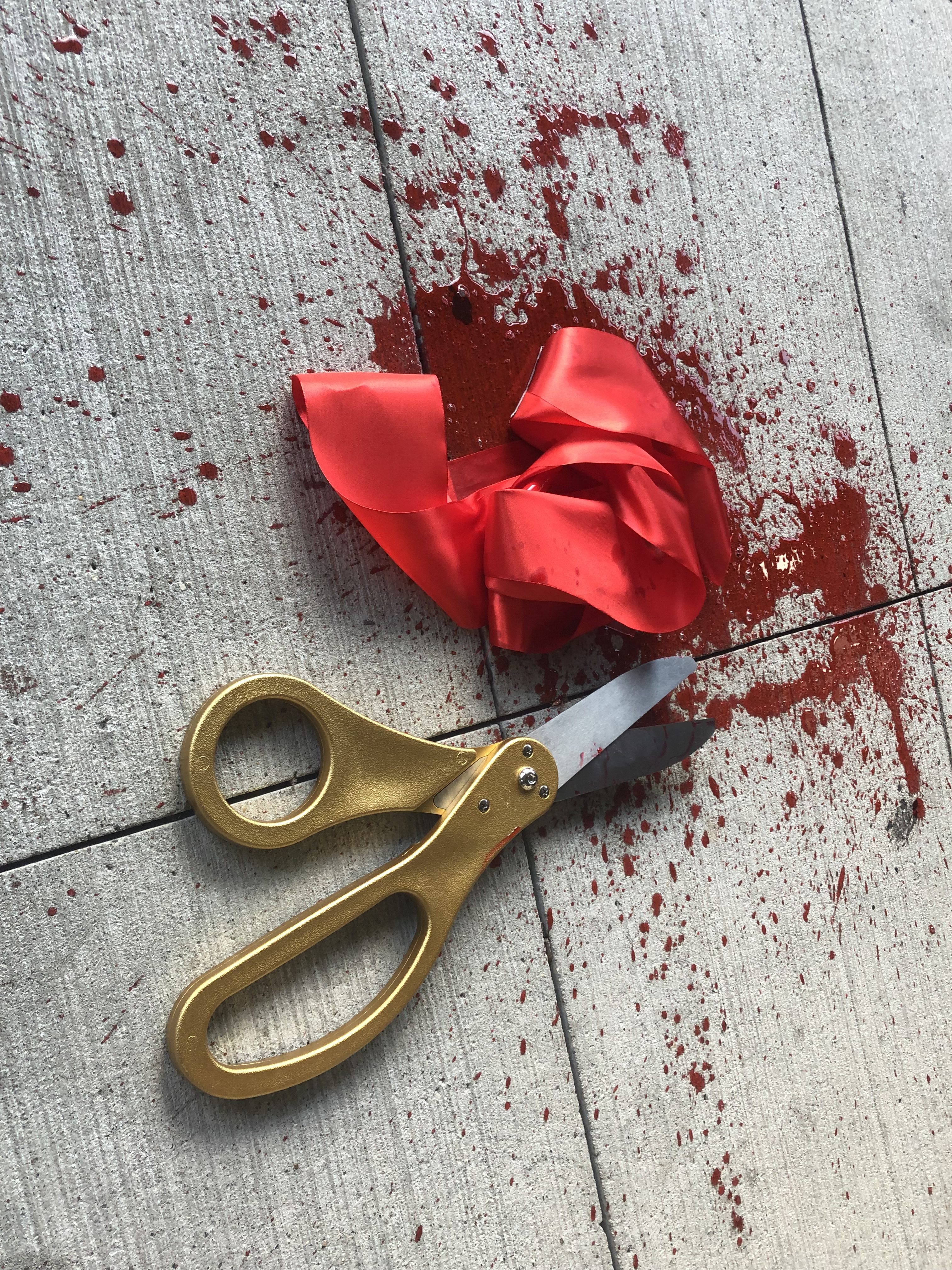 Actor James Jude Courtney slashes the bloody ribbon to open haunted theatrical experience